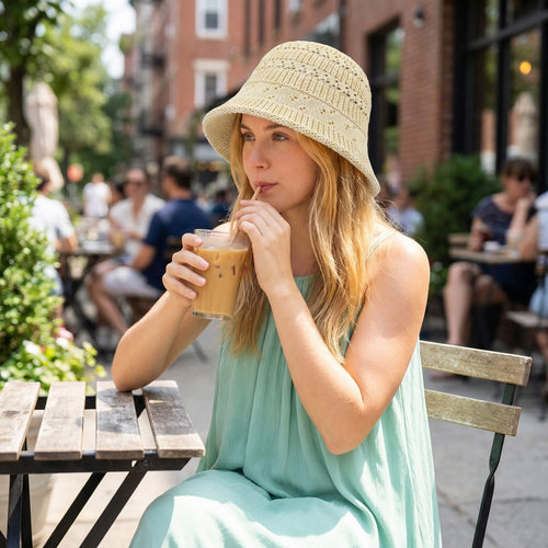 Beige celebrity-inspired cutout bucket hat worn outdoors for summer sun protection